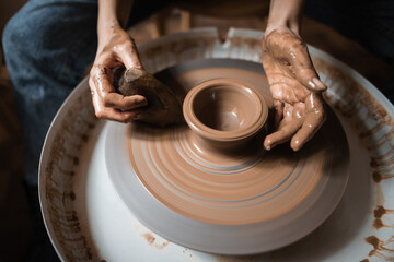 Female Potter Making Vase In Workshop With Natural Light