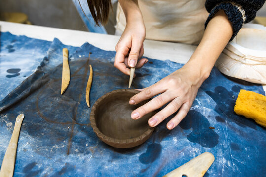 Close Up Of Artesian Hands Working With Clay Bowl