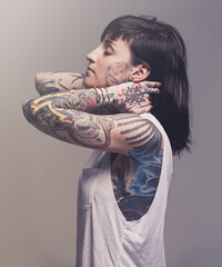 Beautification. A cropped studio portrait of a tattooed young woman.