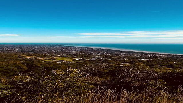 Vertical slow motion video of sea view from a hill