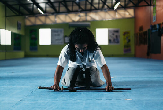 Martial arts fighter sheathing his katana