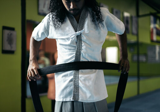 Martial arts fighter putting on the belt