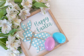 Wooden frame with an Easter Bunny and the inscription 