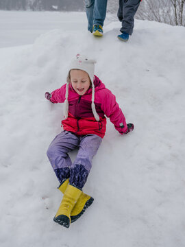 Girl sliding down the snow hill