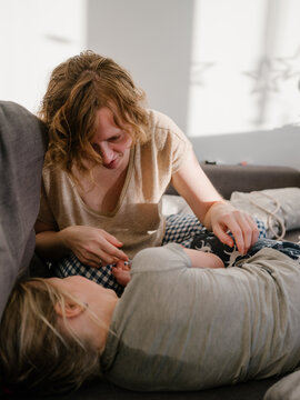 Mother tickling daughter