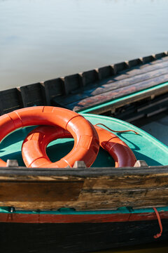 Red lifesavers in old boat on lake