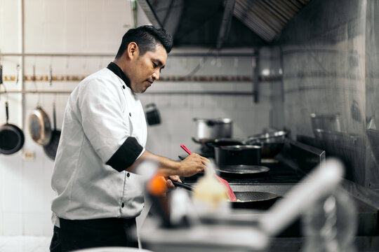 Latin chef cooking in kitchen