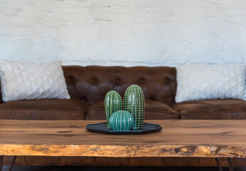 Cactus decoration on wooden table and sofa