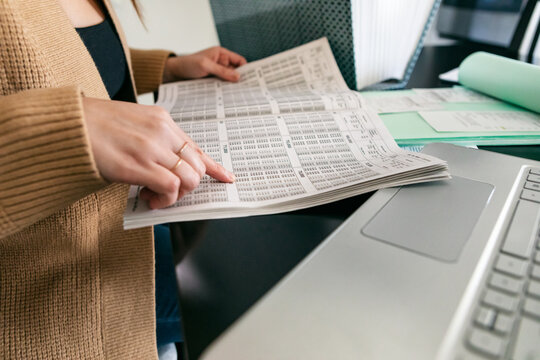 Taxes: Woman Looking At Income Tax Charts