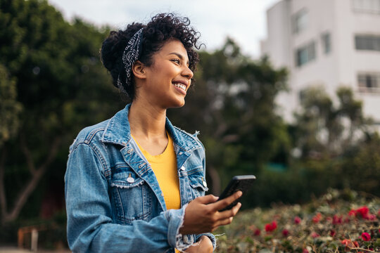Young woman smiling using the smartphone