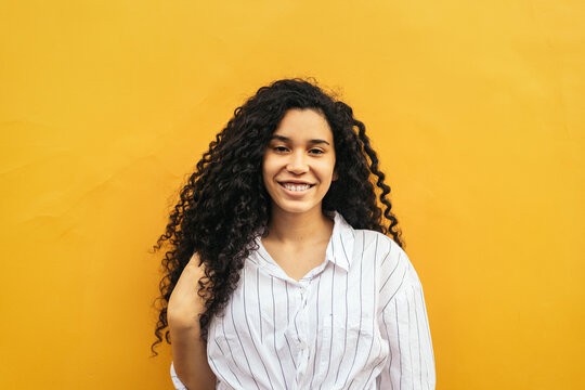 Portrait of young woman with curly hair