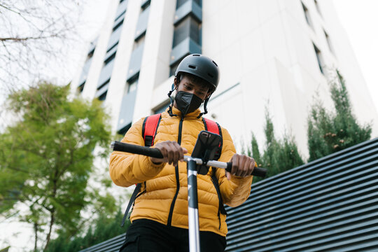 Delivery man checking address on cellphone