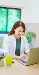 asian woman using laptop