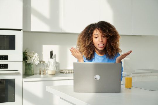 Cheerful woman talking on video call at home