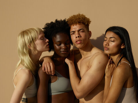 A relaxed group of diverse friends embracing