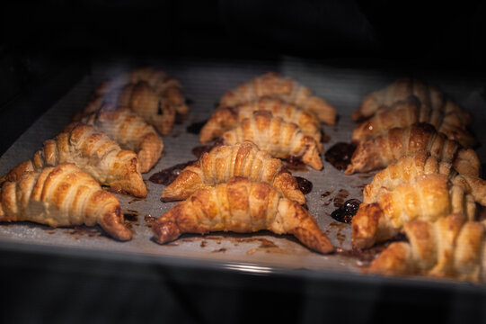 Tasty croissants baking in hot oven