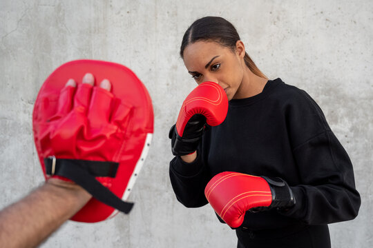 Sportsmen during boxing training with instructor