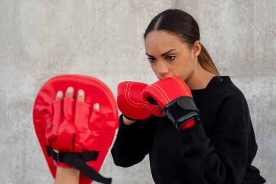 Sportsmen during boxing training with instructor