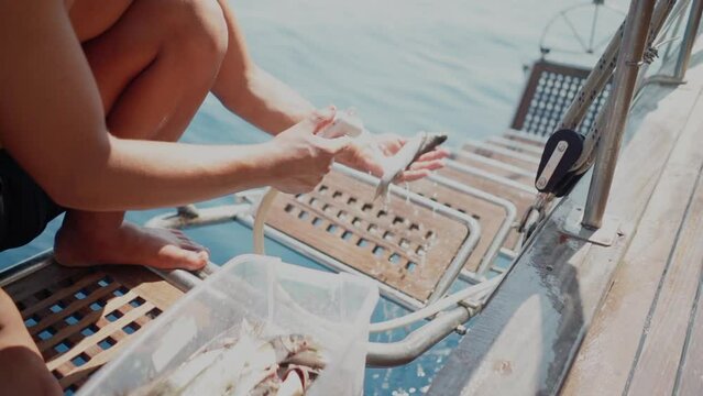 Cook on yacht ship cleans fresh caught fish for delicious seafood meal