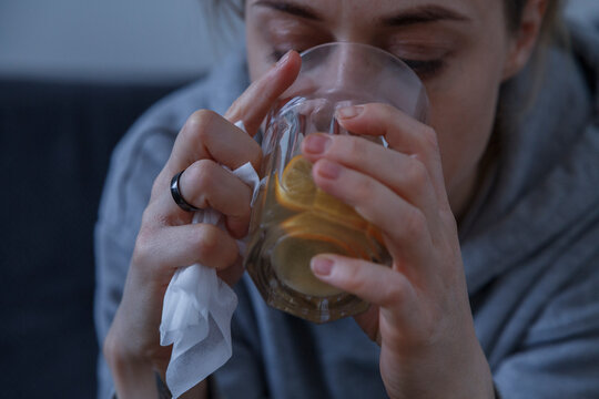 Ill woman drinking healthy tea at home