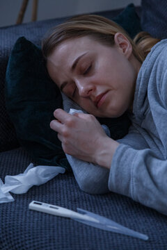 Sick woman with high temperature sleeping at home