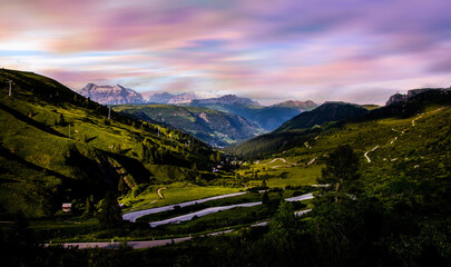 Mountains with alpine village on sunny summer day, the Dolomites Mountains, Italy
