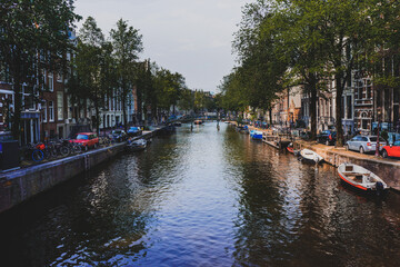 Fototapeta na wymiar AMSTERDAM, NETHERLANDS - May 2019: Canal and St. Nicolas Church in Amsterdam.