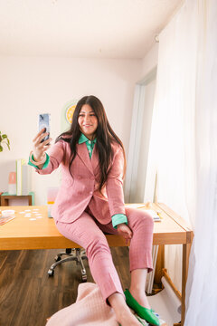 Trendy businesswoman making zoom in cozy office
