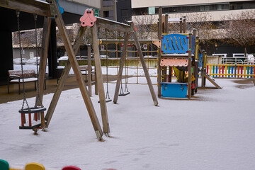 Pamplona, Navarra Spain april 01 2022, Surprise snowfall in early spring, playground covered in snow