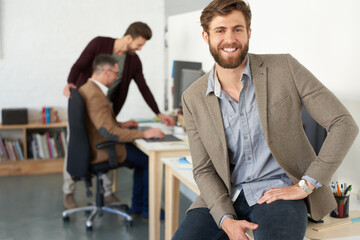 Confident about my creative team. Portrait of a smiling businessman in a modern office.