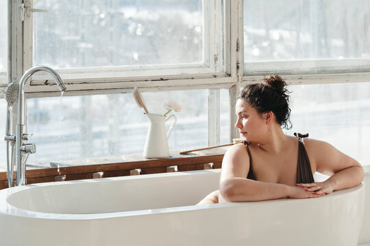 Beautiful plus size woman in bathroom.
