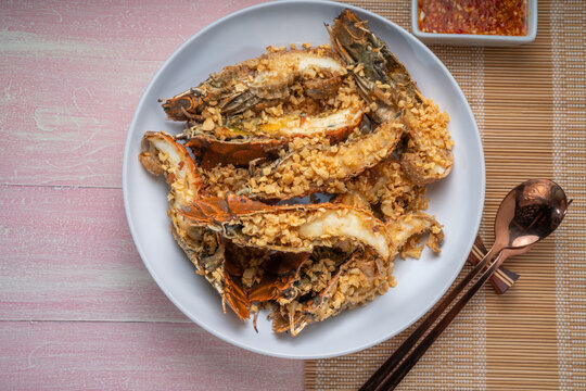 Fried Flathead lobster or Mantis shrimp fried with Garlic and Pepper Served with chili, lime, spicy sauce  , Seafood dish.