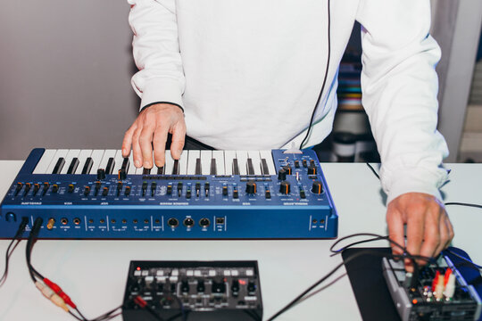 Unrecognizable male person playing synthesizer