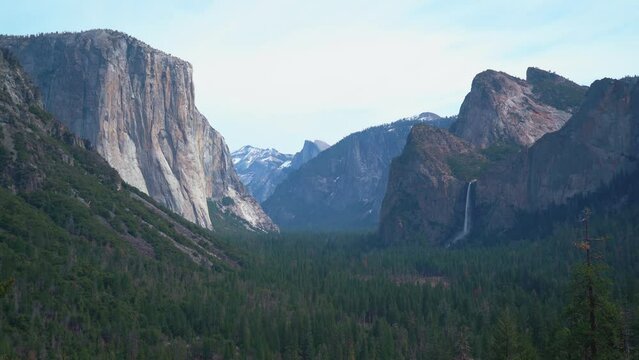 Wide shot of mountain range and spectacular waterfall in Yosemite Valley,America - Panorama view
