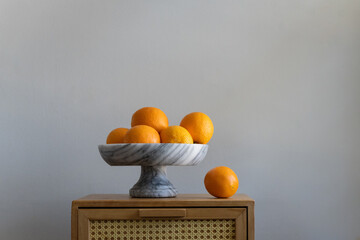 Pretty bowl of oranges on table