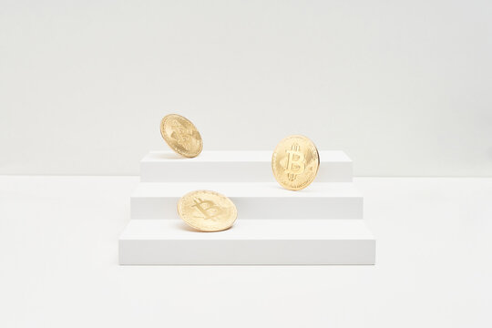 Golden bitcoins falling on steps