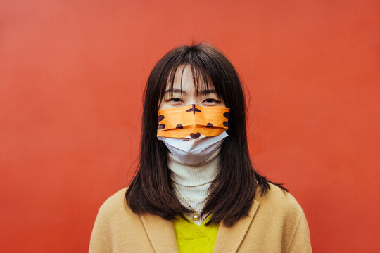 Asian woman with a colorful mask