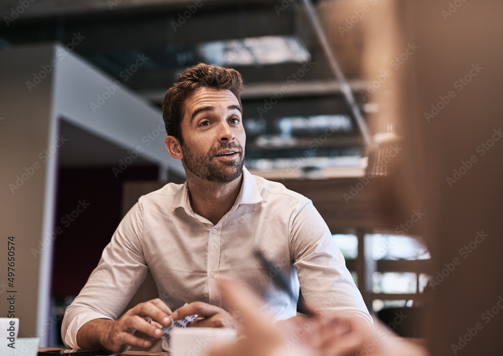 Poster im intrigued by your ideas... do tell me more. shot of a young businessman having a meeting with a c