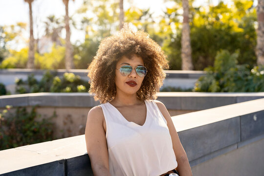 Trendy woman leaning on border