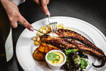 grilled fish on a plate with vegetables