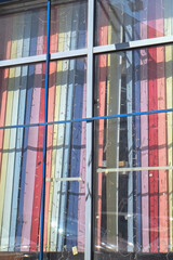 Multicolored blinds outside the window on a spring day
