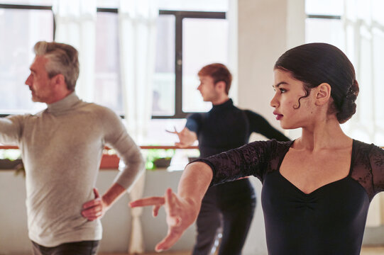 Flamenco dancers and teacher rehearsing in a studio