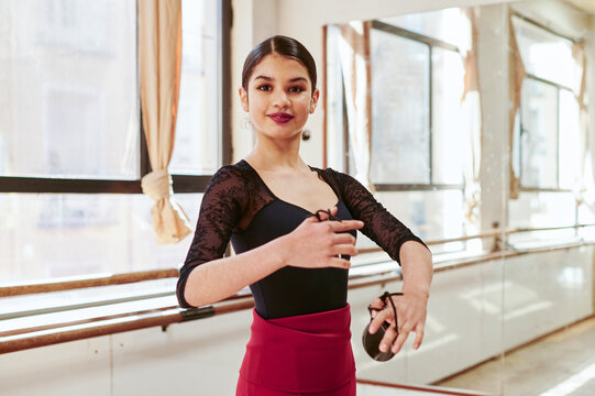 Smiling flamenco dancer rehearsing with castanetas