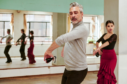Teacher and students flamenco dancing with castanetas