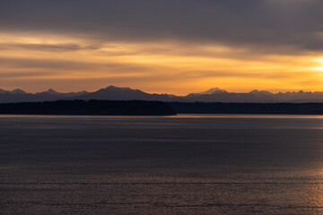 Pacific Northwest sunrise over mountains and bay of water on the Olympic Peninsula, Kingston Washington