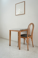 Classic set of wooden chairs and table with wooden blank space photo frame interior on the white marble floor for modern house and decoration living room.