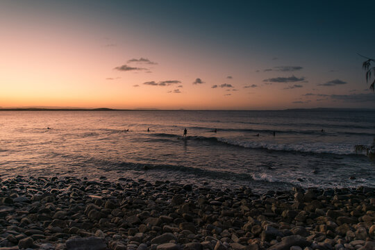 Surfing during striking sunset