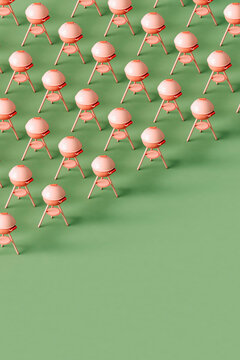 Pink barbeque grill on a green background