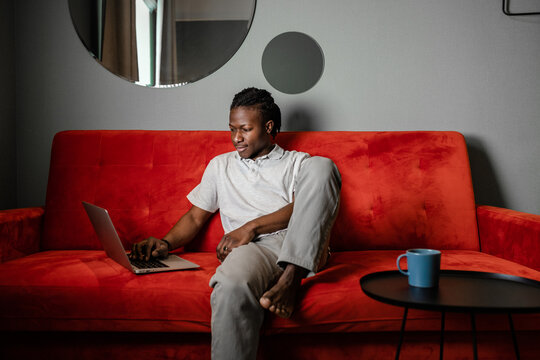 a man at home in comfort working with a laptop