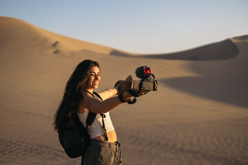 Woman video blogging in the desert